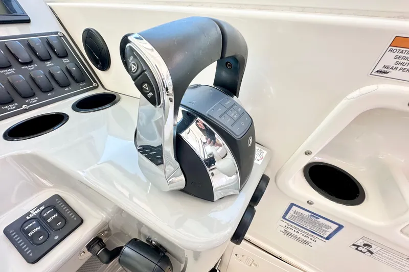 Slide: The Image of Control panel of a 2015 Boston Whaler 315 Conquest boat, featuring throttle and switches. - 25