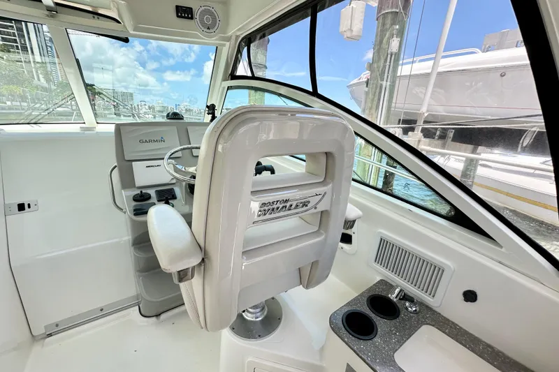 Slide: The Image of 2015 Boston Whaler 315 Conquest helm with Garmin navigation and comfortable seating. - 26