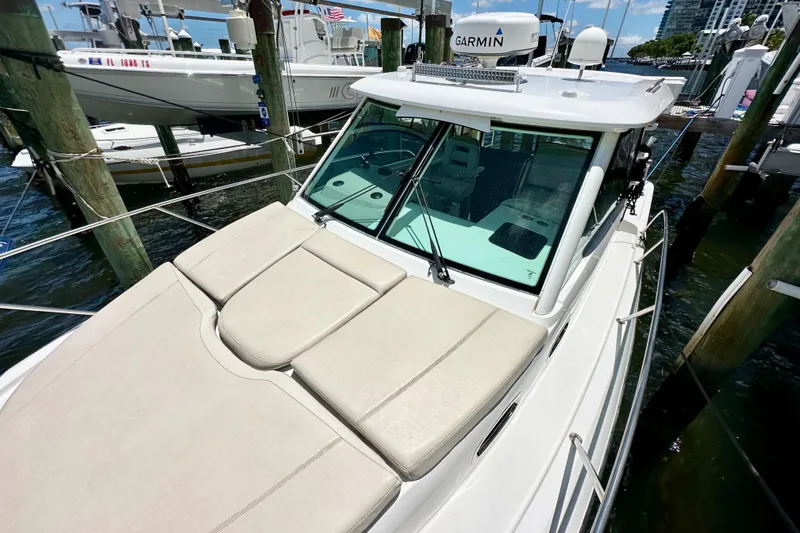 Slide: The Image of 2015 Boston Whaler 315 Conquest docked, featuring spacious deck and modern design. - 3