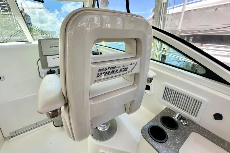 Slide: The Image of Interior of 2015 Boston Whaler 315 Conquest boat with helm seat and control panel. - 32