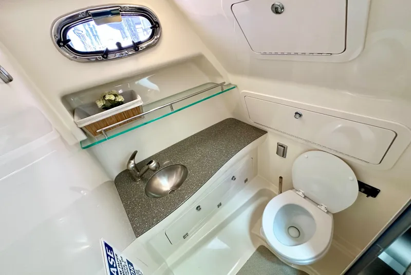 Slide: The Image of 2015 Boston Whaler 315 Conquest bathroom with sink, toilet, and storage. - 34