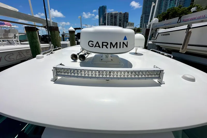 Slide: The Image of 2015 Boston Whaler 315 Conquest with Garmin radar, docked in a marina. - 36