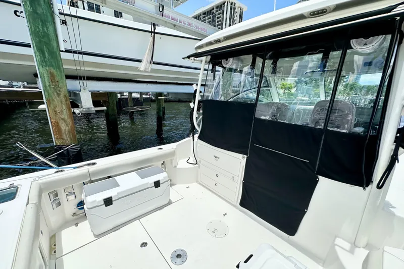 Slide: The Image of 2015 Boston Whaler 315 Conquest boat interior with seating and storage. - 6