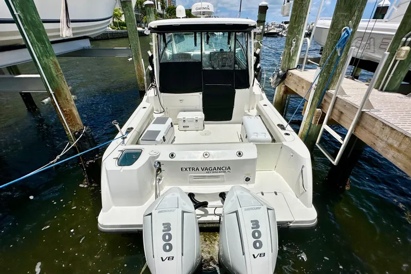 Slide: The Image of 2015 Boston Whaler 315 Conquest docked, featuring twin Mercury 300 V8 engines. - 8