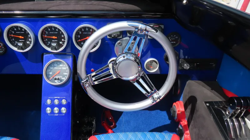 Slide: The Image of 1995 Talon 36 Cat dashboard with chrome steering wheel and blue instrument panel. - 10