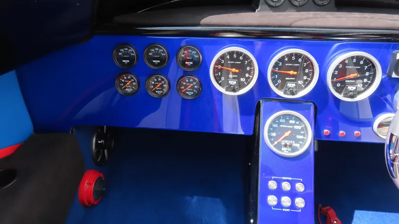 Slide: The Image of Dashboard of a 1995 Talon 36 Cat with multiple gauges and blue accents. - 11