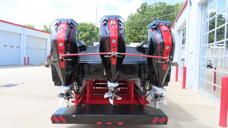Slide: The Image of Triple outboard motors on a 1995 Talon 36 Cat boat, parked at a service facility. - 20