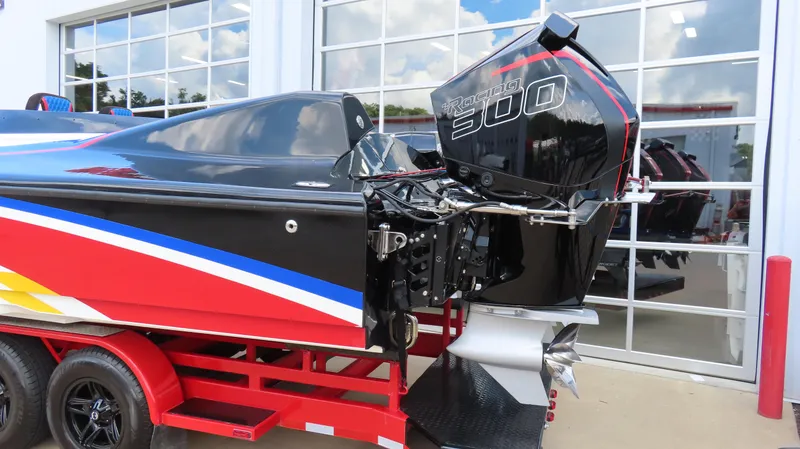 Slide: The Image of 1995 Talon 36 Cat boat with Racing 300 engine, vibrant red, blue, and yellow design. - 21