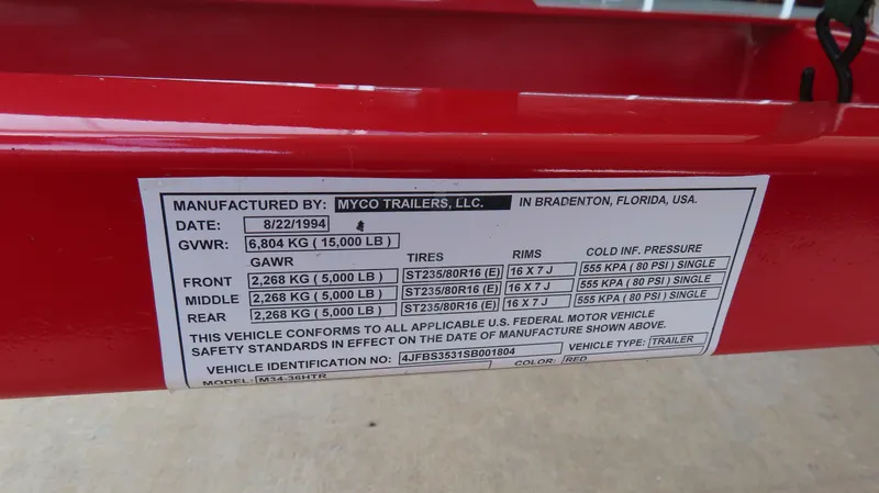 Slide: The Image of Red trailer label with specifications, including GVWR, GAWR, tire details, and manufacturer information. - 26