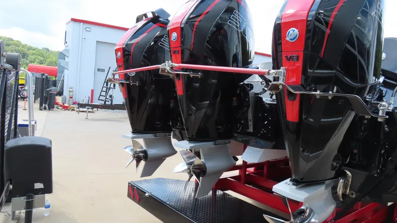 Slide: The Image of Triple V8 outboard engines on a 1995 Talon 36 Cat boat, parked outdoors. - 3