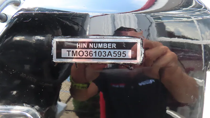 Slide: The Image of HIN number on a 1995 Talon 36 Cat boat, reflective surface. - 4