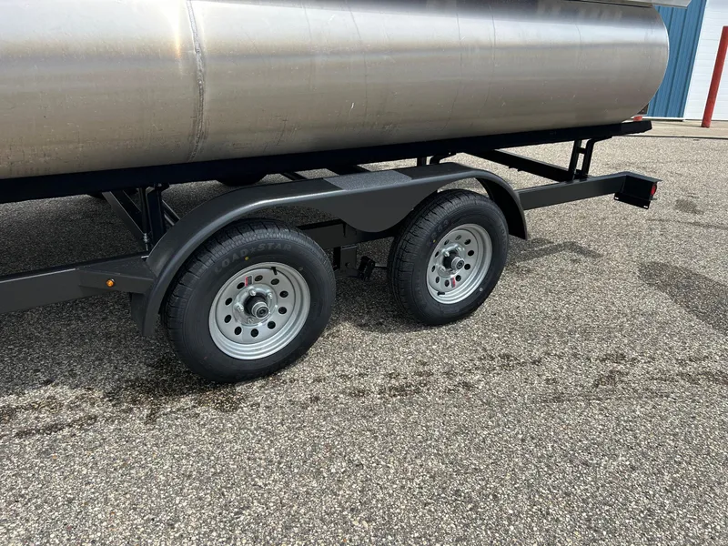Slide: The Image of 2022 Starcraft CX21 trailer with dual wheels on a gravel surface. - 14