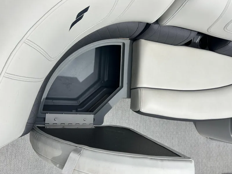 Slide: The Image of 2022 Starcraft CX21 boat seat storage compartment, open with visible interior. - 20