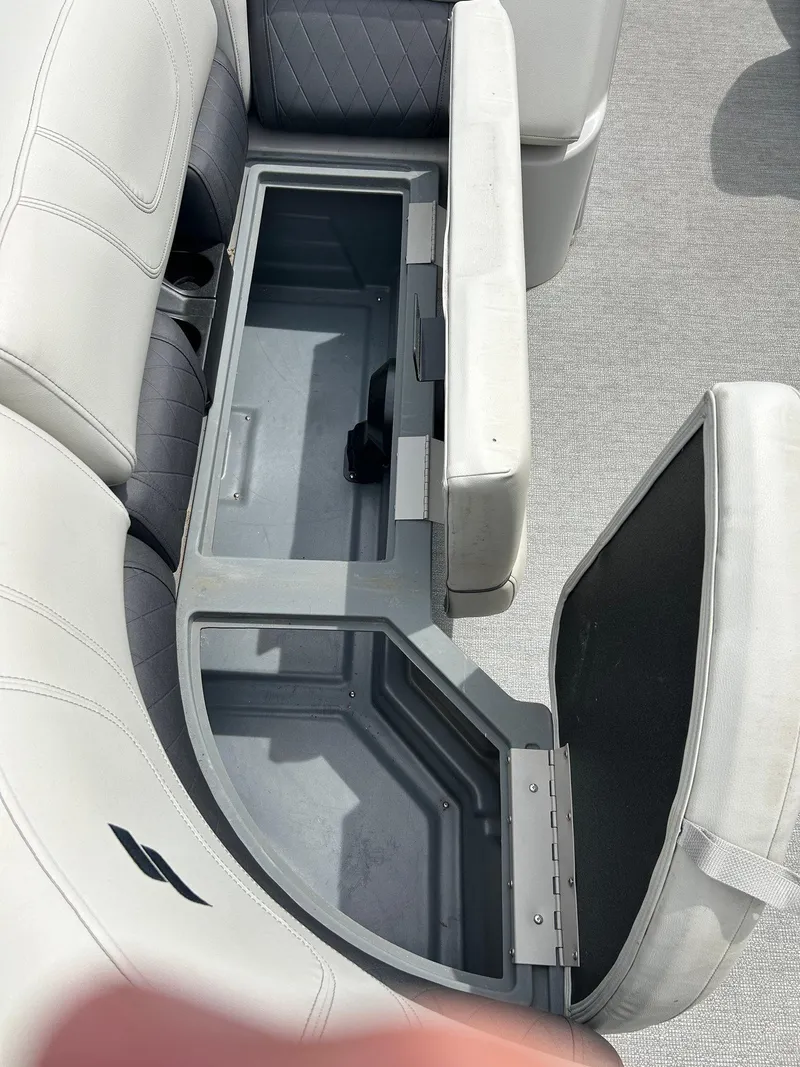 Slide: The Image of Open storage compartment in 2022 Starcraft CX21 boat seat. - 21