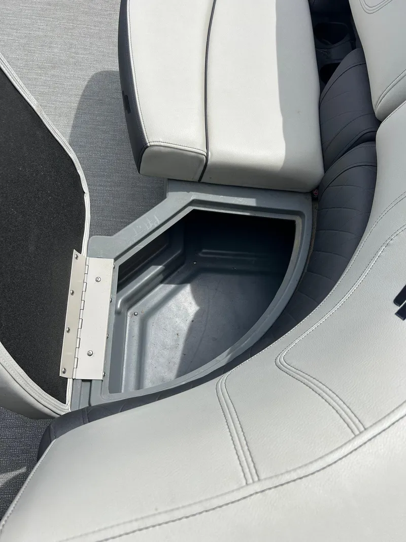 Slide: The Image of 2022 Starcraft CX21 boat seat with open storage compartment. - 22