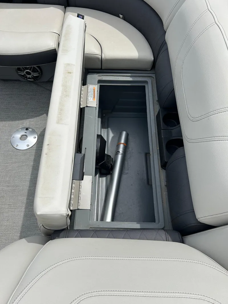 Slide: The Image of Open storage compartment in 2022 Starcraft CX21 boat with gray seating and floor. - 25