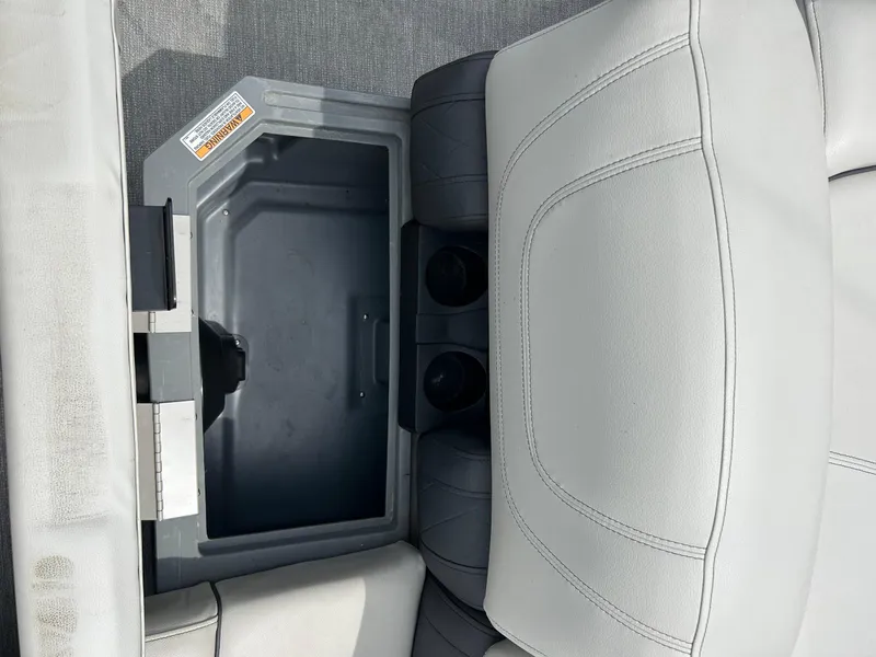 Slide: The Image of Starcraft CX21 2022 boat seat with built-in storage compartment and cup holders. - 26