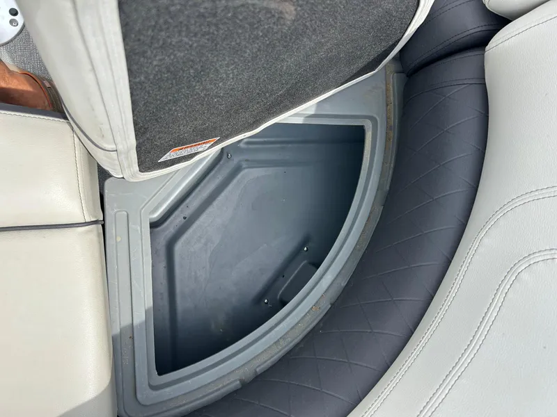 Slide: The Image of Storage compartment in 2022 Starcraft CX21 boat with cushioned seating. - 27