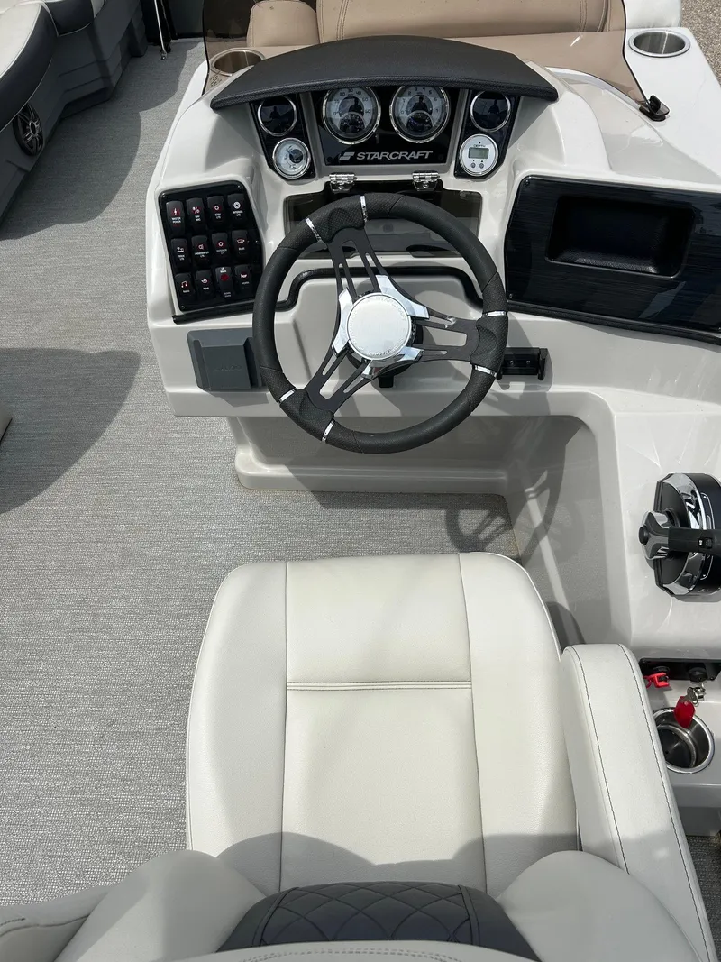 Slide: The Image of 2022 Starcraft CX21 boat dashboard with steering wheel and control panel. - 29