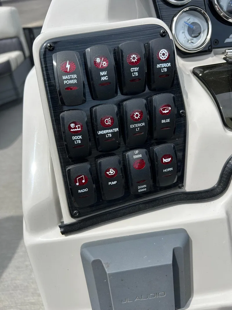 Slide: The Image of Control panel of a 2022 Starcraft CX21 boat with various labeled switches. - 30