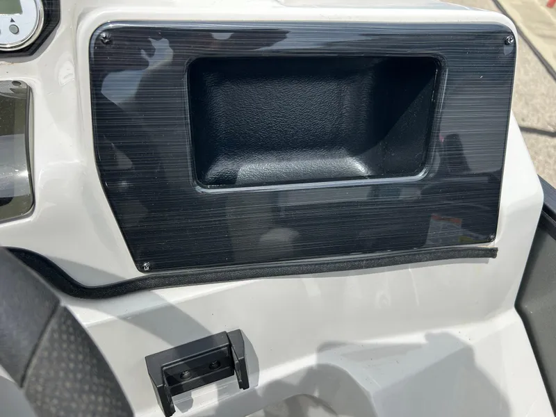 Slide: The Image of Dashboard of 2022 Starcraft CX21 boat with black panel and storage compartment. - 33