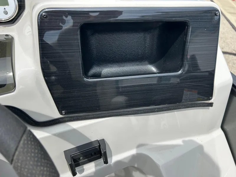 Slide: The Image of Dashboard of 2022 Starcraft CX21 boat with black panel and storage compartment. - 34