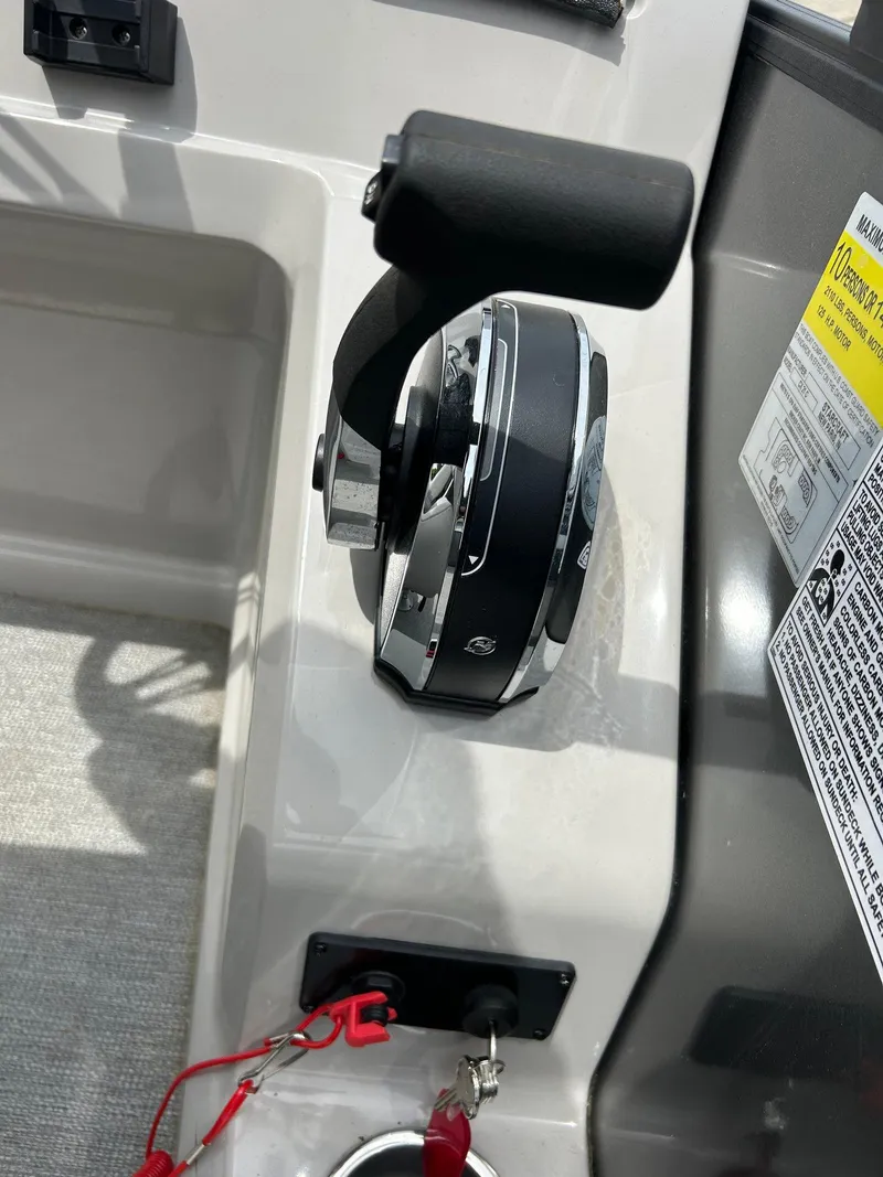 Slide: The Image of 2022 Starcraft CX21 boat throttle control with safety lanyard and warning label. - 37