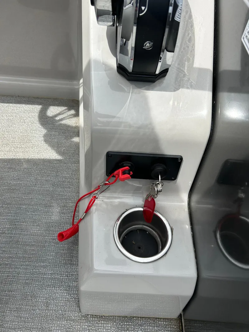 Slide: The Image of 2022 Starcraft CX21 boat console with throttle, ignition key, and red safety lanyard. - 38