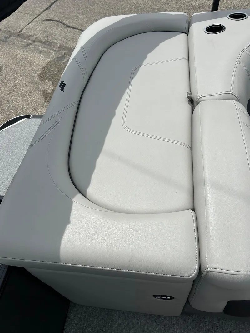Slide: The Image of 2022 Starcraft CX21 boat seat with cup holders, featuring light gray upholstery. - 41