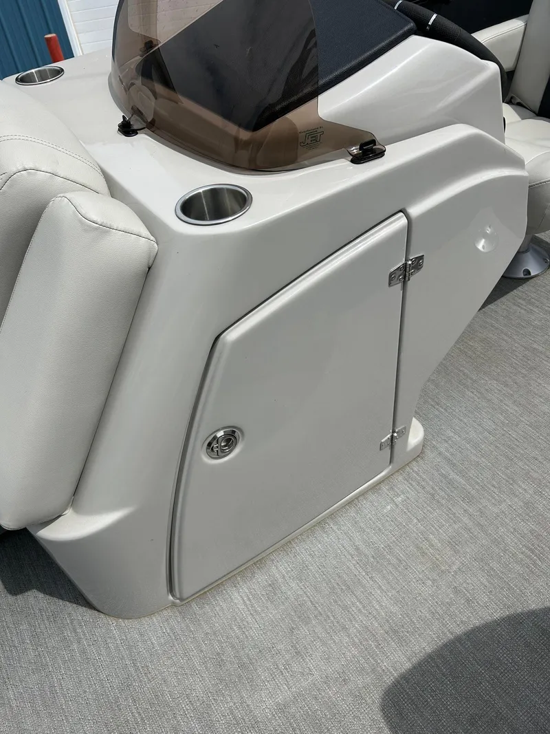 Slide: The Image of 2022 Starcraft CX21 boat console with cup holder and storage compartment. - 43