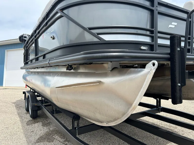 Slide: The Image of 2022 Starcraft CX21 boat with Mercury outboard motor, docked near blue building. - 5