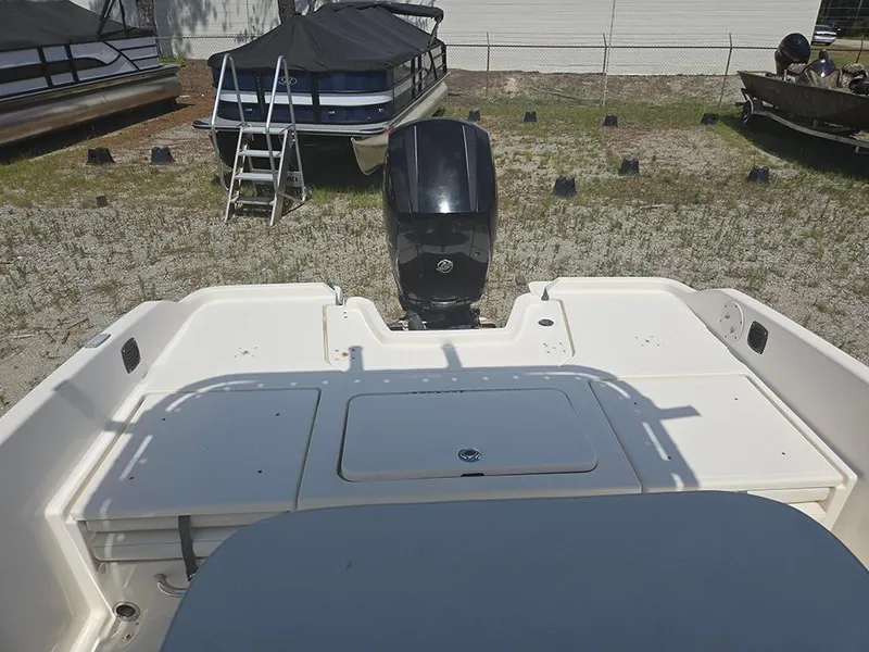 Slide: The Image of 2019 Bayliner Element F21 boat with outboard motor, parked on grass near other boats. - 11