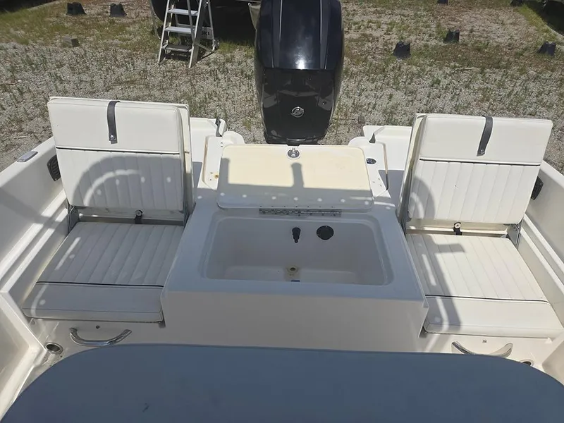 Slide: The Image of 2019 Bayliner Element F21 boat interior with seating and storage compartments. - 12