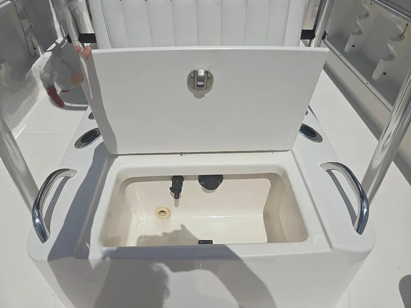 Slide: The Image of 2019 Bayliner Element F21 boat storage compartment with open lid and handles. - 13