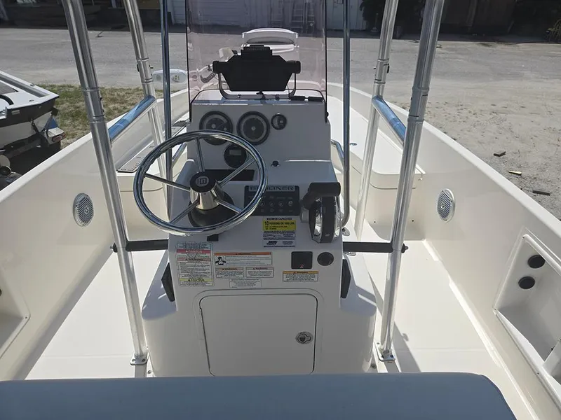 Slide: The Image of 2019 Bayliner Element F21 boat interior with steering wheel and control panel. - 15