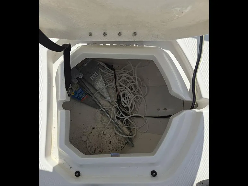 Slide: The Image of 2019 Bayliner Element F21 anchor storage compartment with rope and anchor inside. - 22
