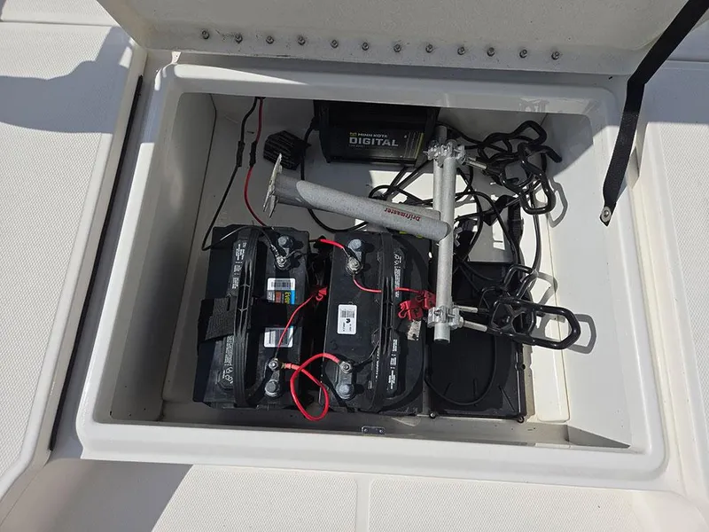 Slide: The Image of 2019 Bayliner Element F21 battery compartment with wiring and equipment. - 24
