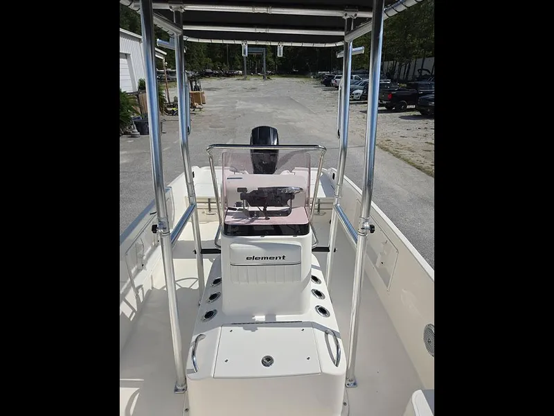Slide: The Image of 2019 Bayliner Element F21 boat interior with steering console and seating area. - 27