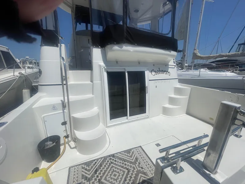 Slide: The Image of 2004 Carver 44 Cockpit Motor Yacht with stairs and sliding doors, docked at marina. - 4