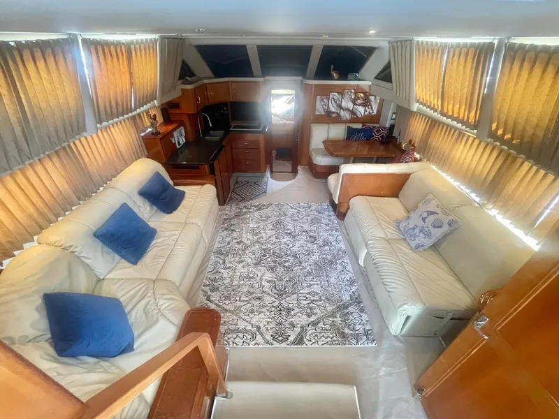 Slide: The Image of Luxurious interior of a 2004 Carver 44 Cockpit Motor Yacht with plush seating and elegant decor. - 47