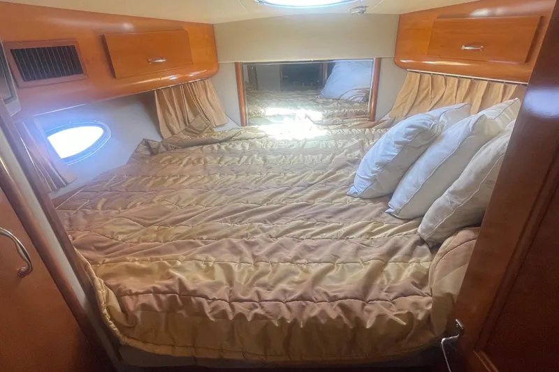 Slide: The Image of Luxurious bedroom interior of 2004 Carver 44 Cockpit Motor Yacht with plush bedding. - 59