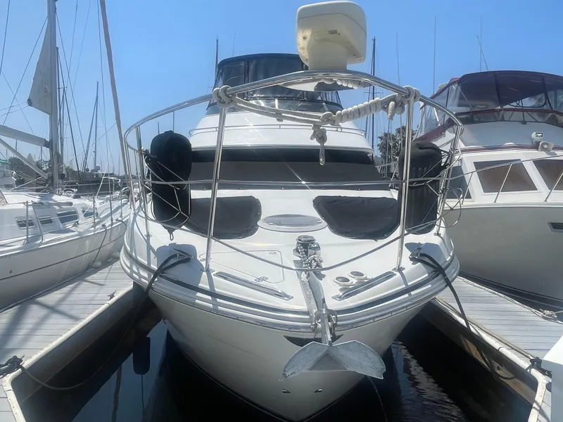 Slide: The Image of 2004 Carver 44 Cockpit Motor Yacht docked at marina, front view. - 2