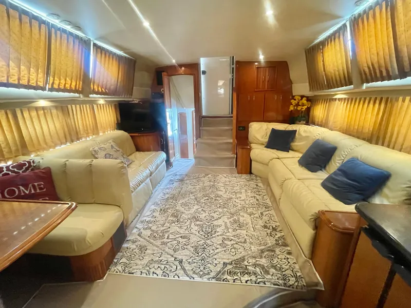 Slide: The Image of Luxurious interior of a 2004 Carver 44 Cockpit Motor Yacht with plush seating and elegant decor. - 48
