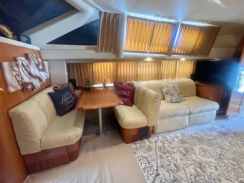 Slide: The Image of Interior of 2004 Carver 44 Cockpit Motor Yacht with cozy seating and dining area. - 50
