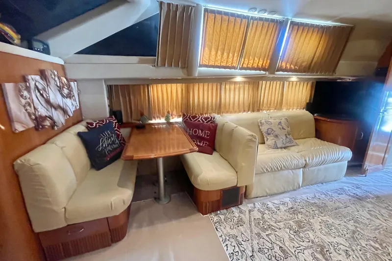 Slide: The Image of Interior of 2004 Carver 44 Cockpit Motor Yacht with cozy seating and dining area. - 55