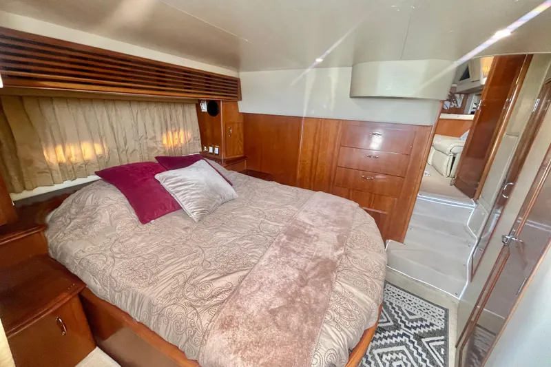 Slide: The Image of Luxurious bedroom interior of 2004 Carver 44 Cockpit Motor Yacht with elegant wood finish. - 57