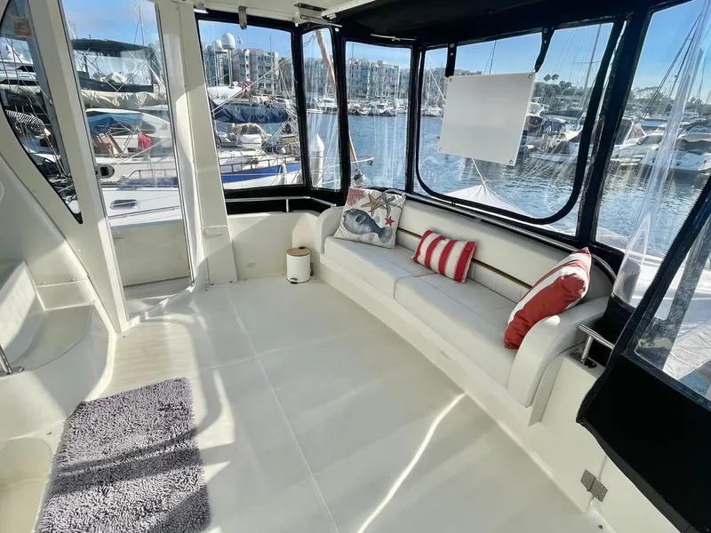 Slide: The Image of Spacious cockpit of 2004 Carver 44 Motor Yacht with comfortable seating and marina view. - 8