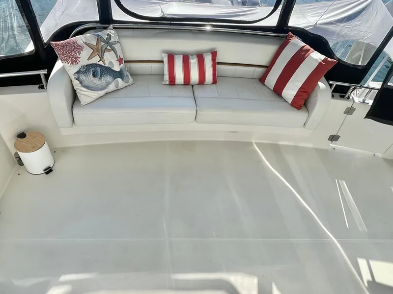 Slide: The Image of 2004 Carver 44 Cockpit Motor Yacht interior with striped cushions and decorative pillows. - 9