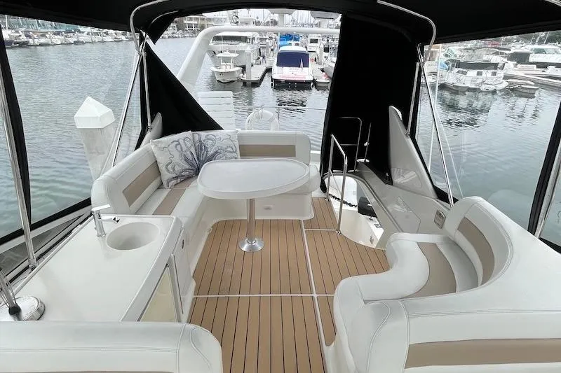 Slide: The Image of Luxurious 2006 Carver 42 Super Sport yacht interior with elegant seating and table. - 19