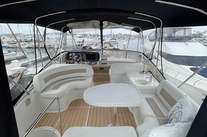 Slide: The Image of 2006 Carver 42 Super Sport yacht interior with seating and helm, docked at marina. - 20